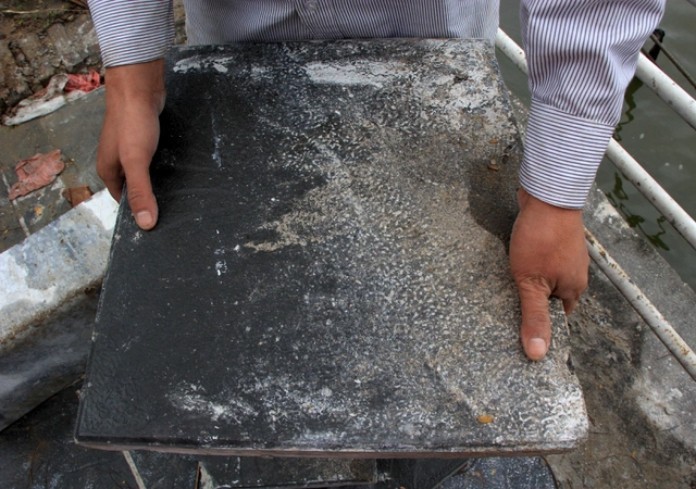 
Những viên gạch bê tông vân đá này có kích thước 40 x 40 x 05cm, nặng khoảng 15kg, có màu xám giống đá
