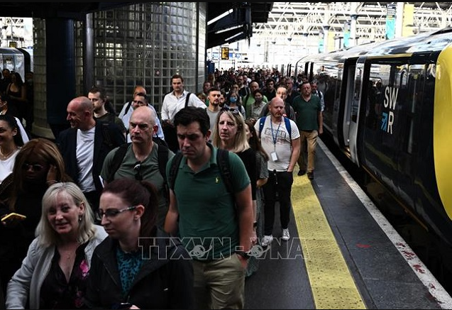 
Hành khách rời khỏi tàu tại nhà ga Waterloo ở thủ đô London, Anh, khi các công nhân tiến hành đình công kêu gọi tăng lương, ngày 21/6/2022. Ảnh: TTXVN
